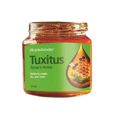 Jar of Tuxitus syrup in honey with green label on a white background